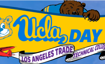 Bruin holding UCLA Day sign