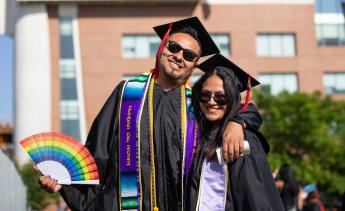 Graduate with rainbow fan