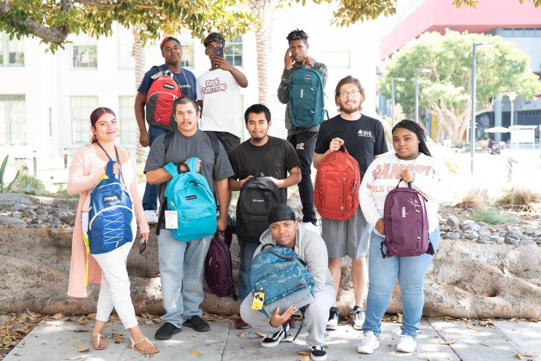 Foster youth holding backpacks