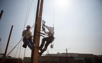 Electricians Working on a Light Post