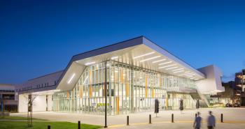 Evening image of Culinary Arts Building with people walking in