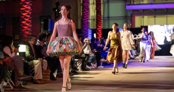 Models walking down runway during fashion show