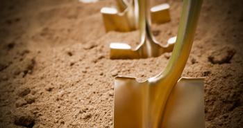Gold shovels in dirt