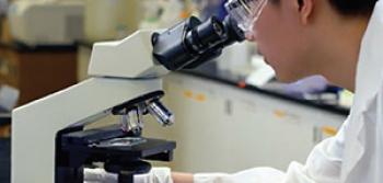 Student Using a Microscope in a Lab