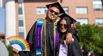 Graduate with rainbow fan
