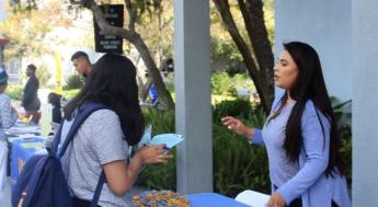 Student speaking with university representative