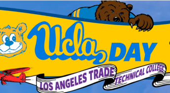 Bruin holding UCLA Day sign