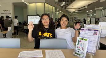 Student service representatives smiling and waving