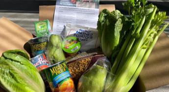 Food Pantry box with produce and canned goods