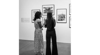 two girls viewing art exhibit