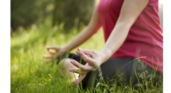 person practicing yoga on grass