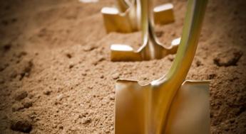 Gold shovels in dirt