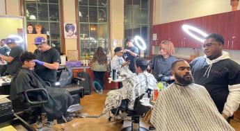 Barbers cutting clients' hair