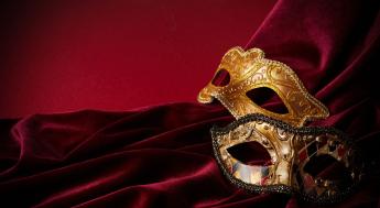 Two masquerade masks on red velvet