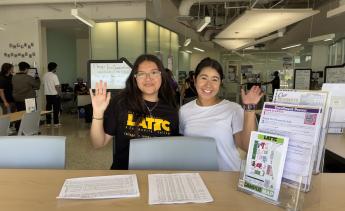 Student service representatives smiling and waving
