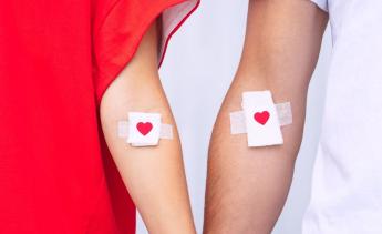 Two arms with heart bandages