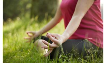 person practicing yoga on grass