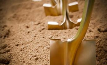 Gold shovels in dirt