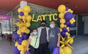 Student with parents in front of balloons and LATTC letters