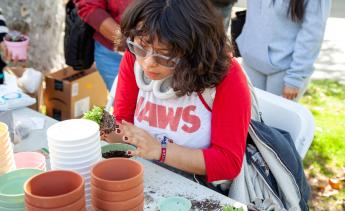 Student gardening at table