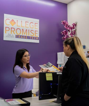 Counselor showing pamphlet to student