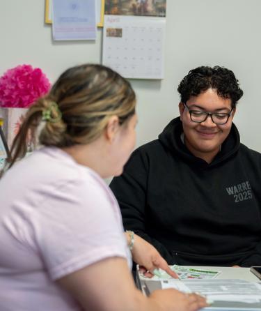 Counselors showing class brochure to student