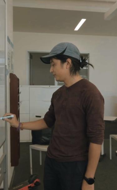 Tutor writing on white board