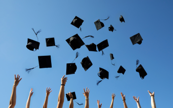 Graduates throwing caps to the sky