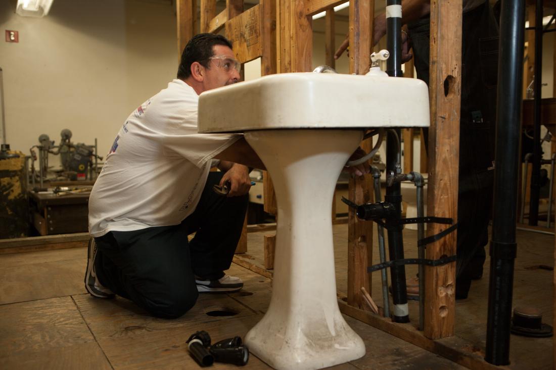 Man Fixing a Sink 