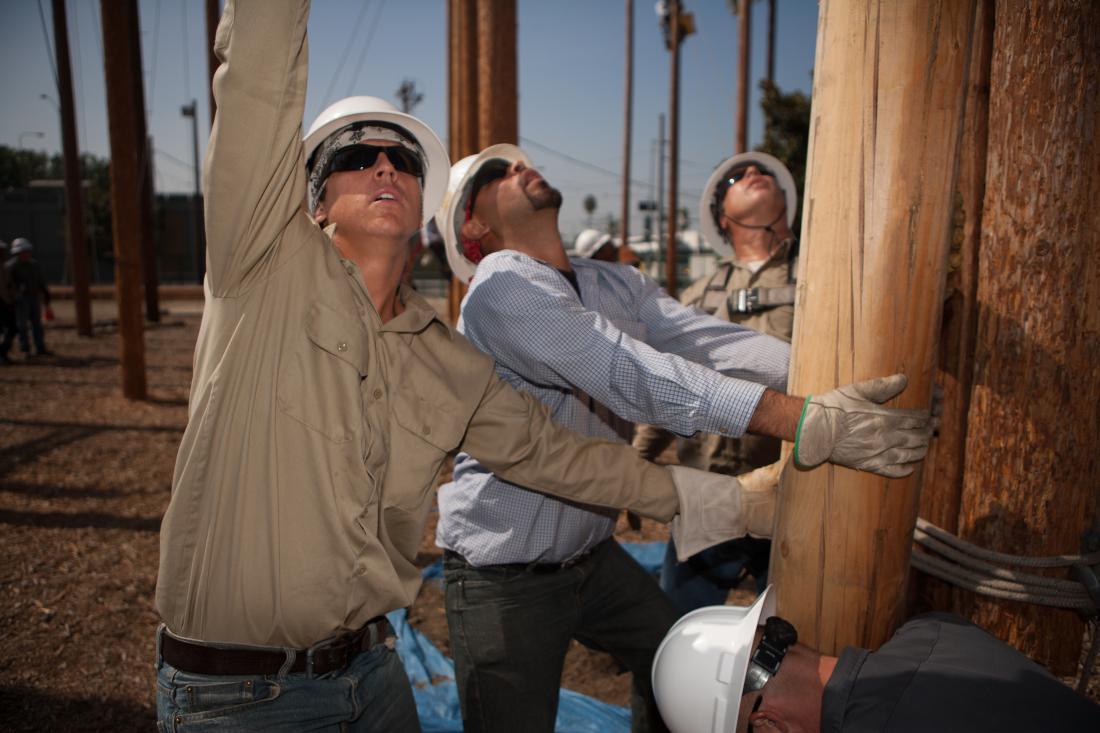 Electricians Working on a Light Post