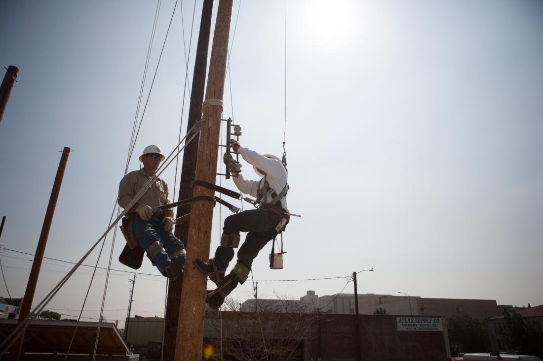 Electricians Working on a Light Post
