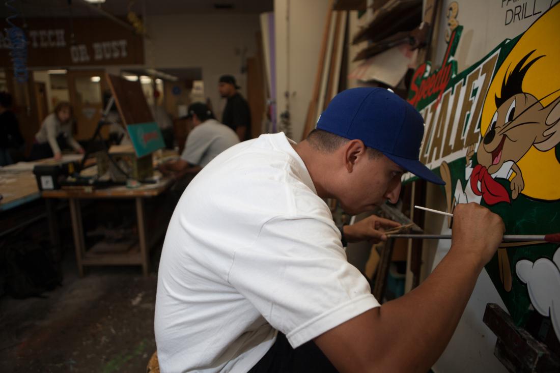 Graphic Student Painting a Speedy Gonzalez Sign