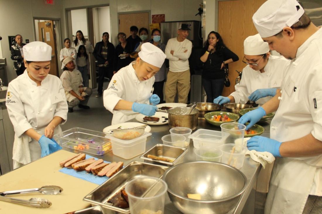 Students working in the kitchen during the final moments of the savory competition