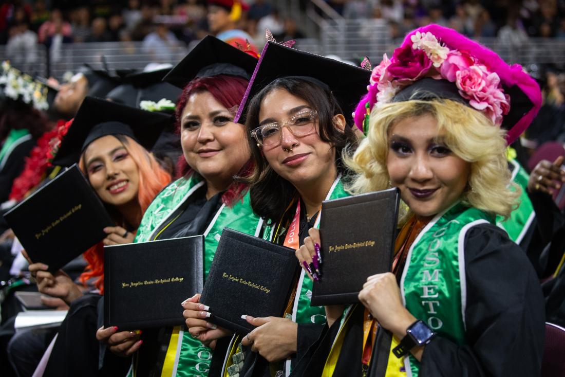 2023 Graduates smile with their diplomas