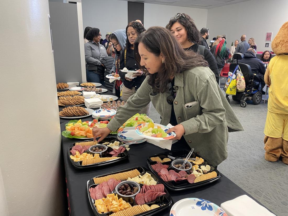 Guests enjoying food during Basic Needs opening celebration