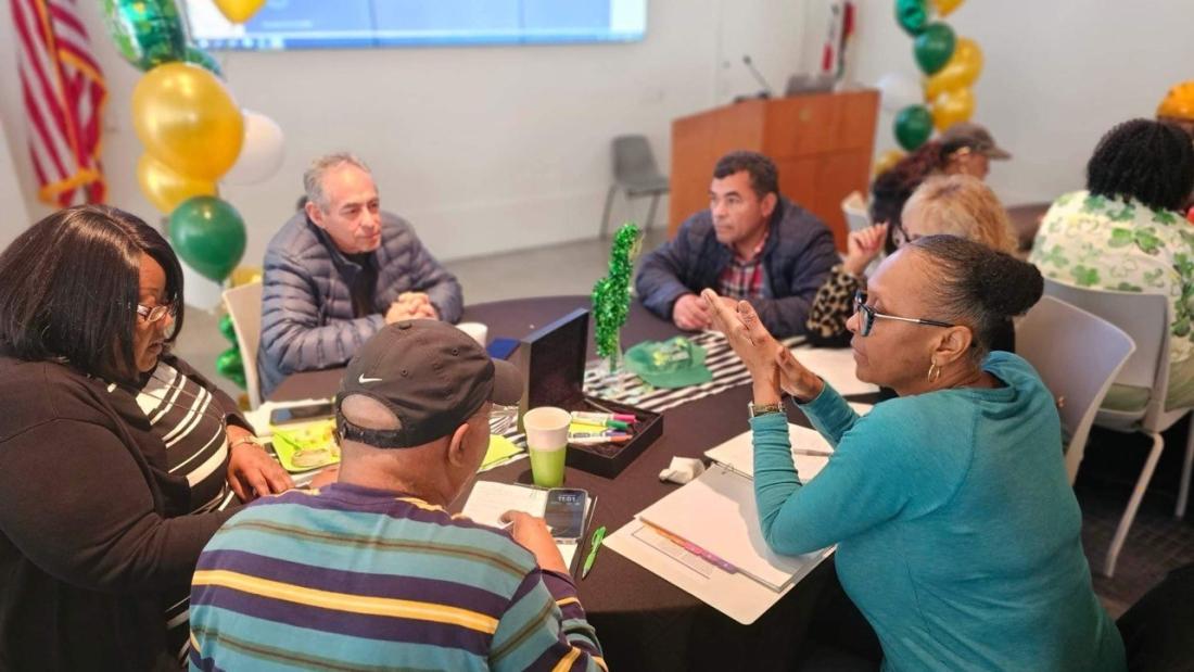 Foster parents gathering at table during workshop