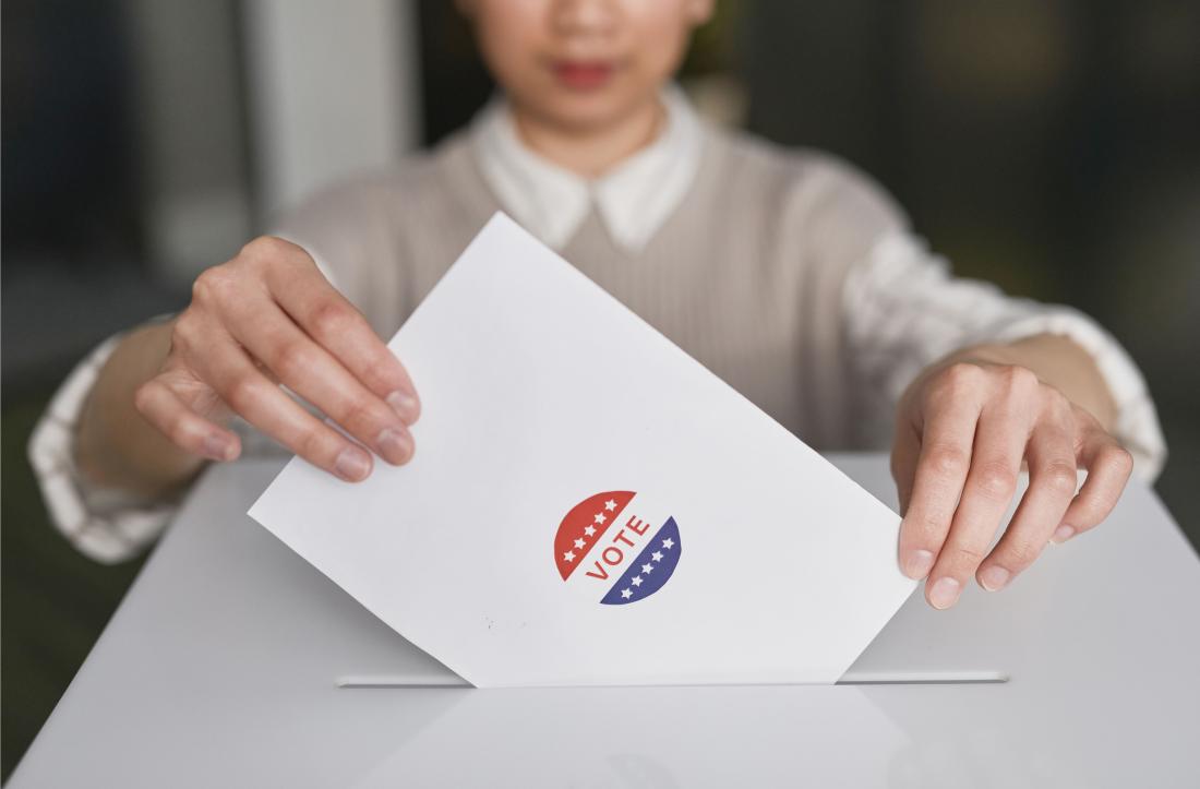 Person casting ballot in box
