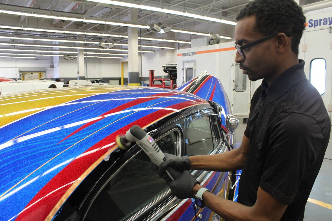 Student polishing 1948 Chevy Fleetline lowrider