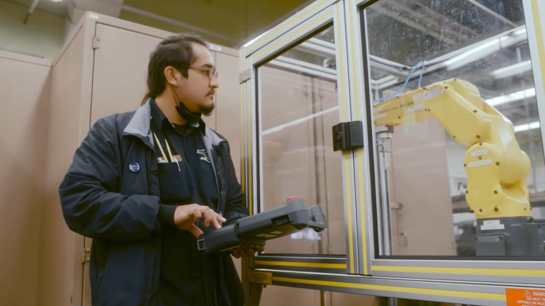 Student using controller to maneuver machine