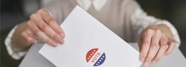 Person casting ballot in box