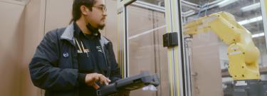 Student using controller to maneuver machine