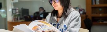 Student wearing UCLA sweatshirt browsing admission brochure