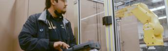 Student using controller to maneuver machine